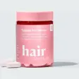 Rosa boks med Hairlust Hair Formula Tablets for Women og to lyse rosa tabletter foran